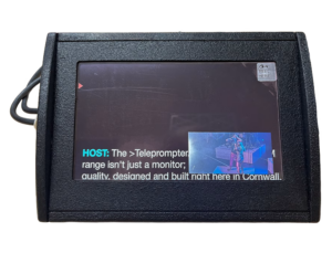 Close-up of a black teleprompter monitor showing text on screen and a small inset video window.
